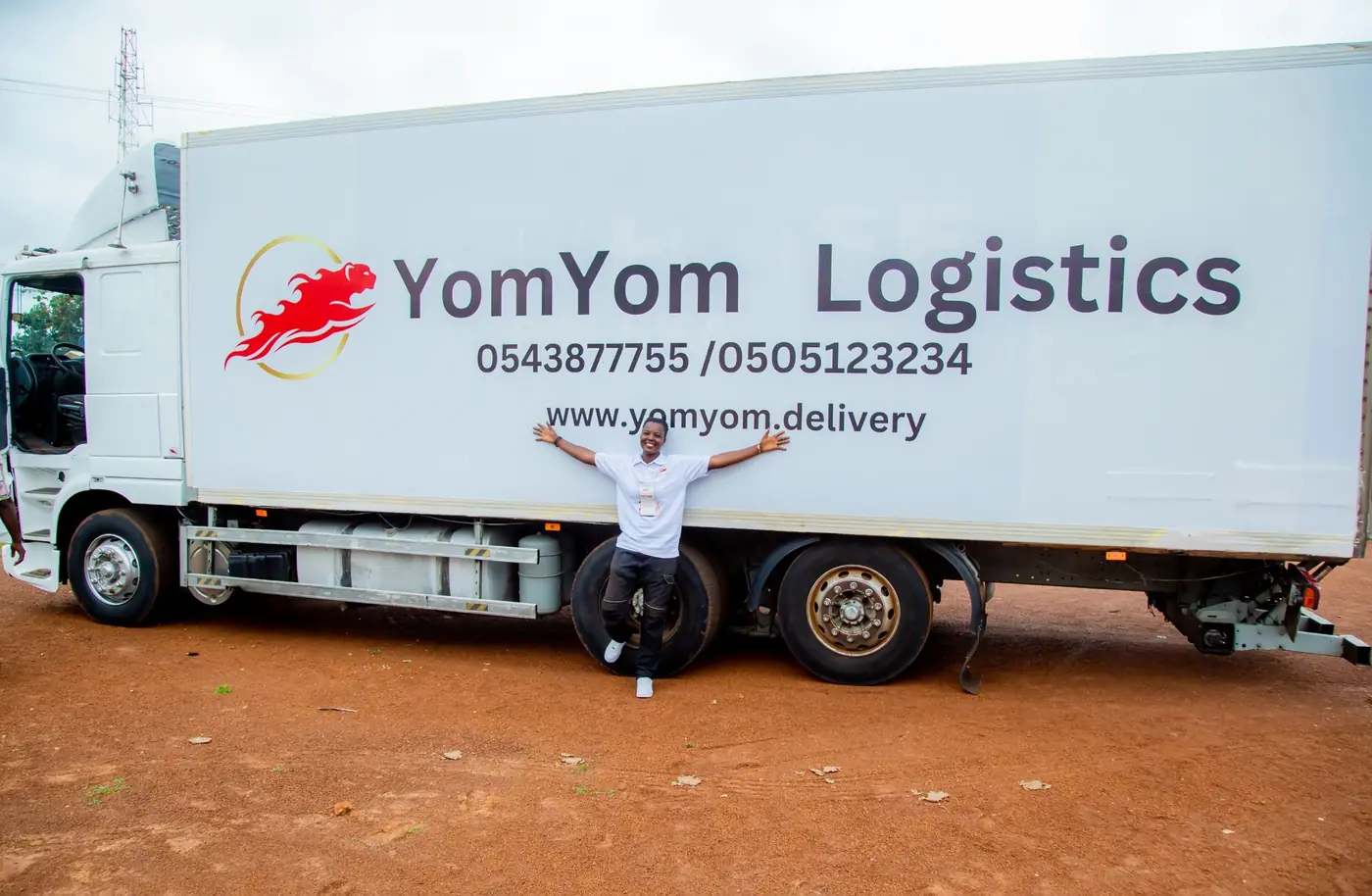 YomYom team member in front of a YomYom Logistics truck