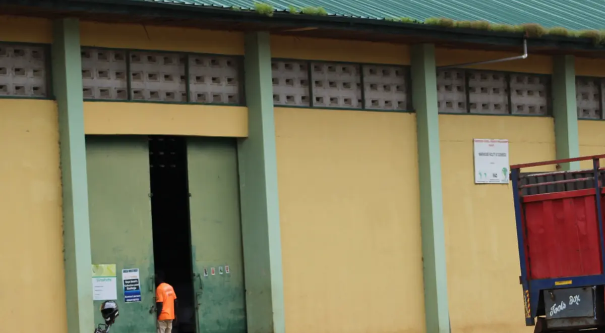 A warehouse with a truck parked outside